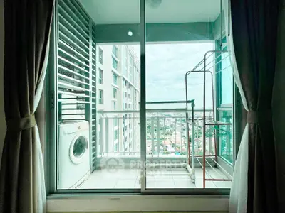 Modern apartment balcony with city view and washing machine, perfect for urban living.