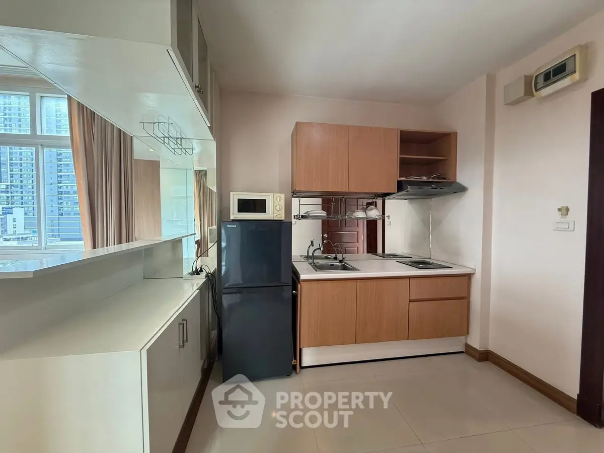 Modern kitchen with sleek cabinets and appliances in a high-rise apartment