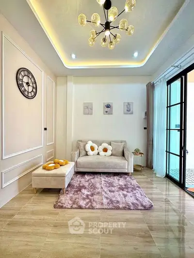Chic living room with modern chandelier, cozy sofa, and elegant decor in a stylish apartment.