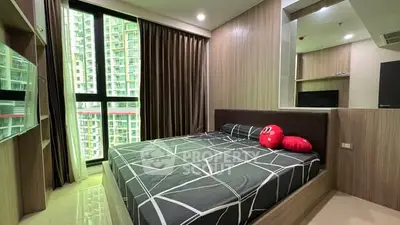 Modern bedroom with large window and stylish decor in high-rise apartment