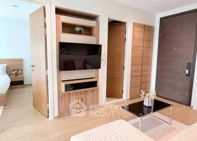 Modern living room with wooden accents and sleek TV setup in a stylish apartment.
