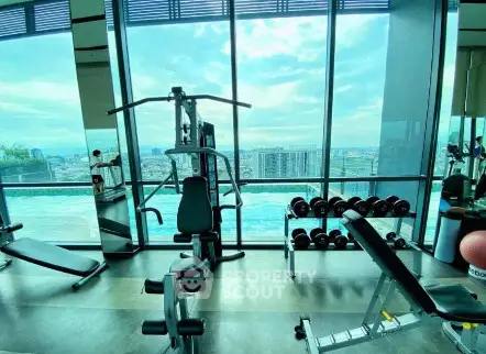 Modern gym with panoramic city views and state-of-the-art equipment.