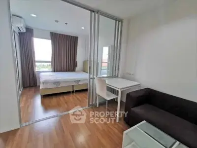 Modern studio apartment with glass partition, cozy living area, and natural light.