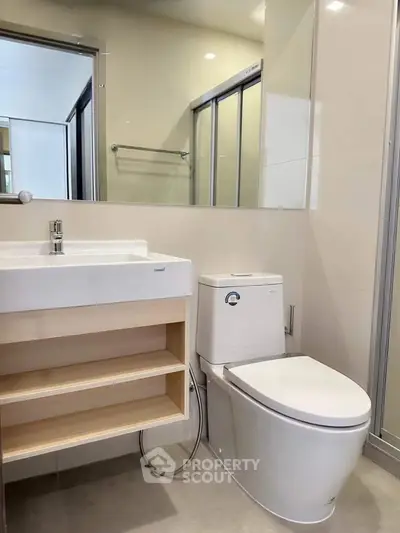 Modern bathroom with sleek fixtures and spacious shower area