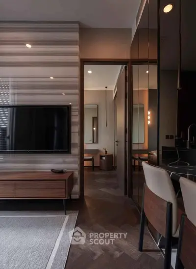 Modern living room with stylish decor and open view into adjacent room