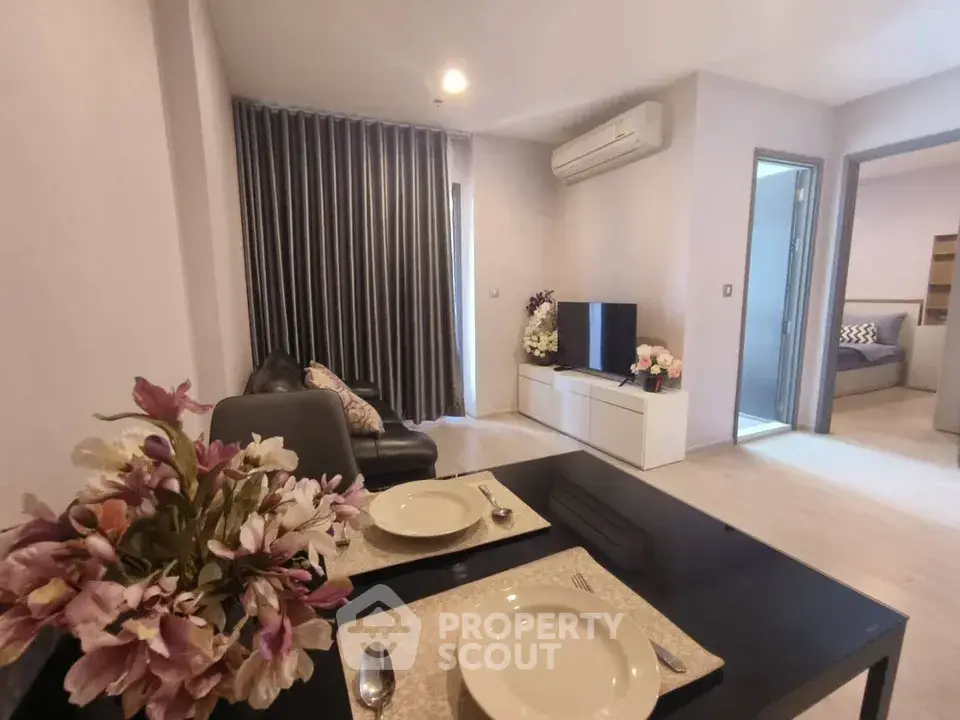 Modern living room with dining area in a stylish apartment featuring elegant decor and natural light.