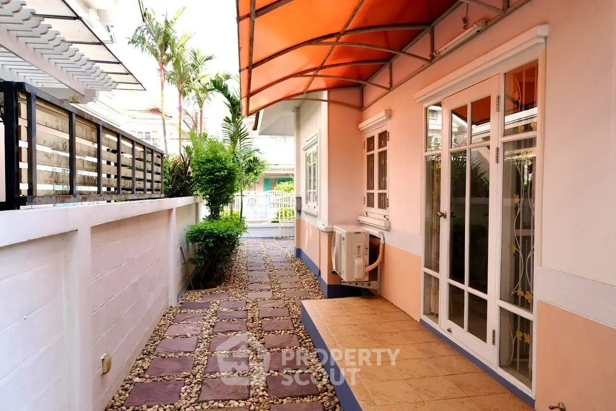 Charming exterior view of a modern home with a stylish walkway and lush greenery.