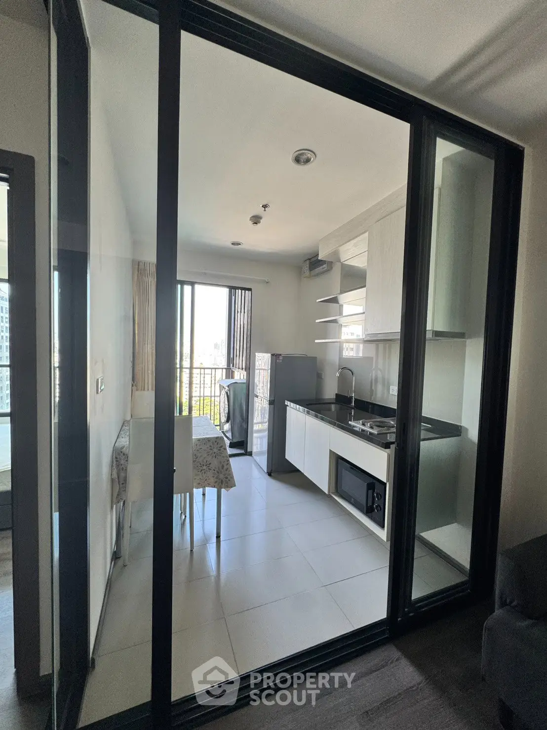 Modern kitchen with open layout and balcony view in a stylish apartment