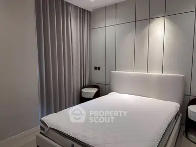 Modern bedroom with sleek design and elegant furnishings, featuring a comfortable bed and stylish side tables.