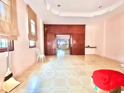 Spacious living room with tiled flooring and natural light