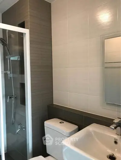 Modern bathroom with sleek shower and elegant fixtures in a contemporary apartment.