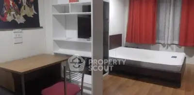 Cozy studio apartment with modern furnishings and wooden flooring, ideal for urban living.