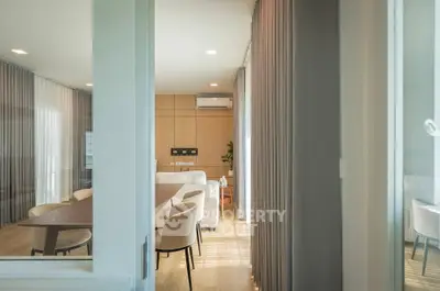 Modern living room with elegant furniture and natural light, featuring a cozy seating area and stylish decor.