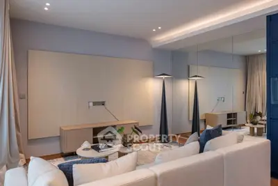 Modern living room with elegant decor and stylish lighting, featuring a cozy seating area and contemporary design.