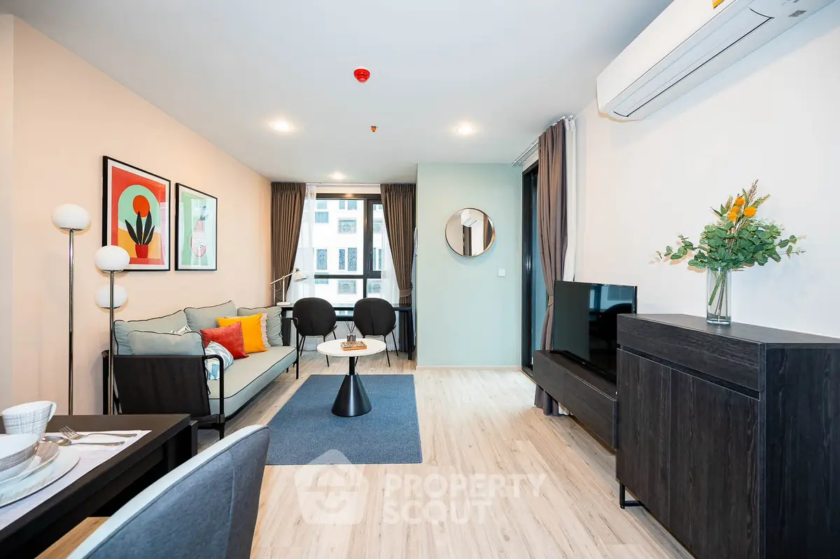 Modern living room with stylish decor and natural light in a contemporary apartment.