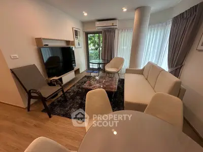 Modern living room with stylish furniture and large windows offering natural light.