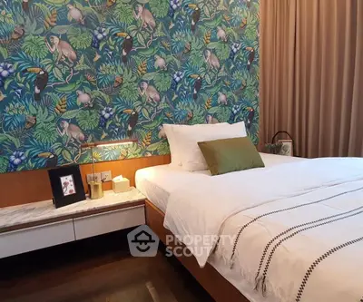 Charming bedroom with vibrant jungle-themed wallpaper and cozy bed setup.