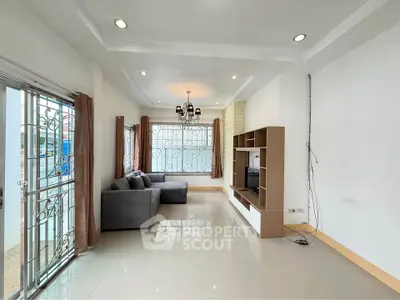 Spacious living room with modern decor and large windows for natural light
