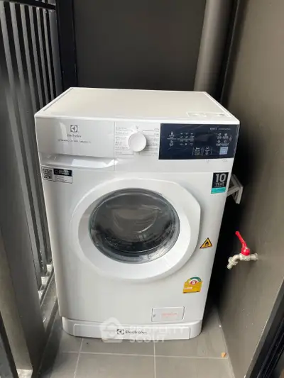 Modern Electrolux washing machine in a compact laundry space, perfect for urban living.