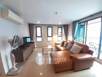 Spacious living room with modern furniture and large windows for natural light.