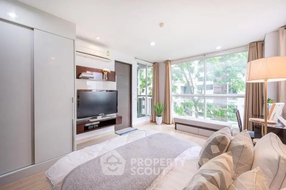 Bright and airy bedroom with large windows and modern decor