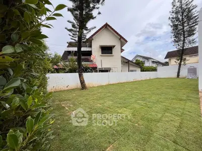 Charming suburban home with spacious green lawn and privacy fence, ideal for family living.