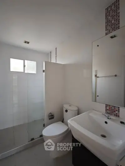 Modern bathroom with glass shower and sleek fixtures