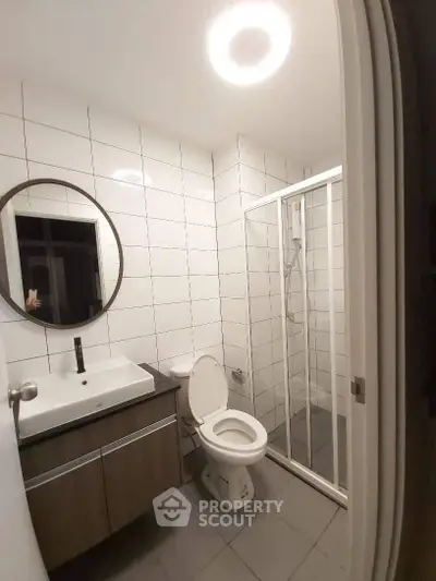 Modern bathroom with sleek fixtures and glass shower enclosure