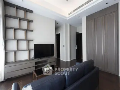 Modern living room with stylish shelving and sleek TV setup, perfect for contemporary living.