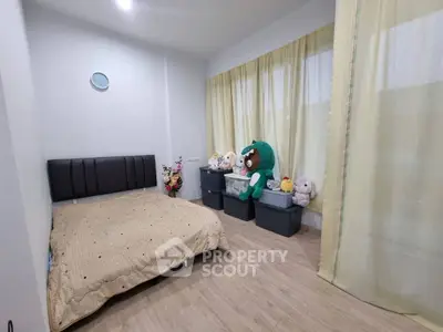 Cozy bedroom with plush toys and soft lighting, perfect for relaxation.