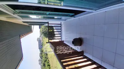 Spacious balcony with scenic view and wooden railing in modern home