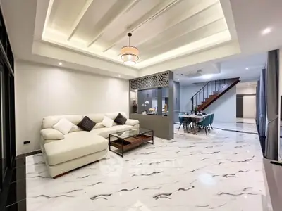 Luxurious open-plan living room with elegant marble flooring and modern decor