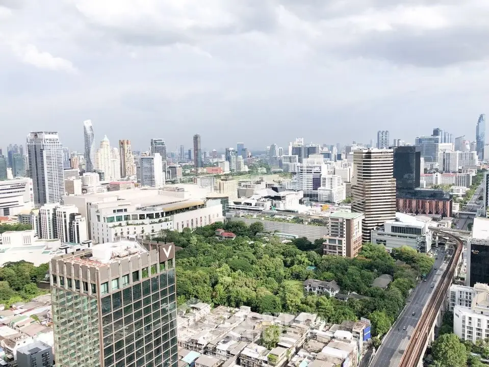 Stunning cityscape view showcasing urban skyline and lush greenery, perfect for real estate investment.