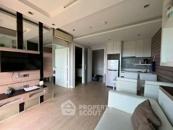 Modern open-layout living room with sleek kitchen and stylish decor