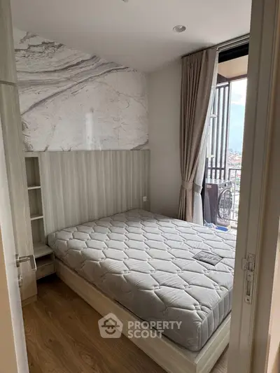 Cozy bedroom with balcony access and stylish decor