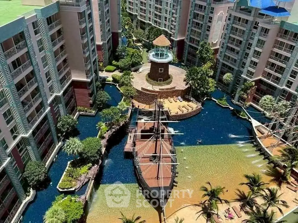 Luxurious condo complex with unique ship-themed pool and lush landscaping.
