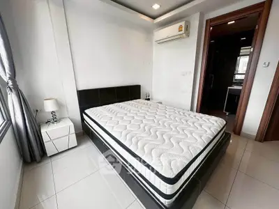 Modern bedroom with sleek design and air conditioning in a bright apartment.