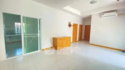 Spacious living room with modern air conditioning and ample natural light.