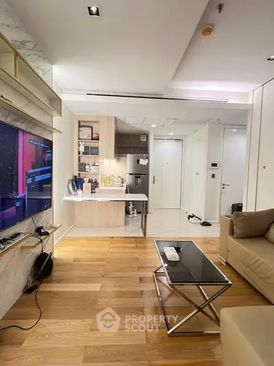 Modern living room with open kitchen and sleek wooden flooring