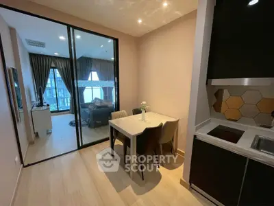 Modern apartment with open layout, dining area, and cozy living room with large windows.