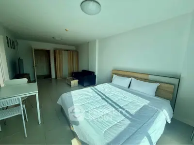 Spacious bedroom with modern furnishings and ample natural light