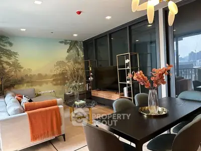 Stylish living room with modern decor and large windows offering a scenic view, perfect for relaxation and entertainment.