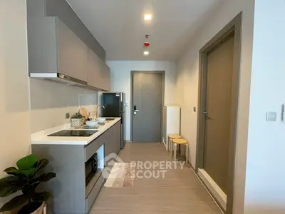Modern kitchen with sleek cabinetry and integrated appliances in a stylish apartment.