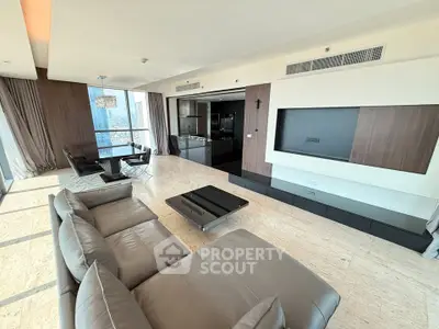 Luxurious modern living room with panoramic city view and sleek furnishings.