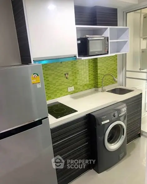 Modern kitchen with sleek appliances and vibrant green backsplash