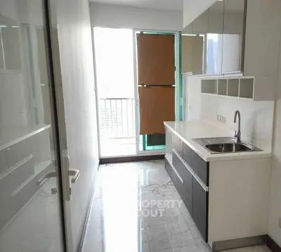 Modern kitchen with sleek cabinets and balcony view