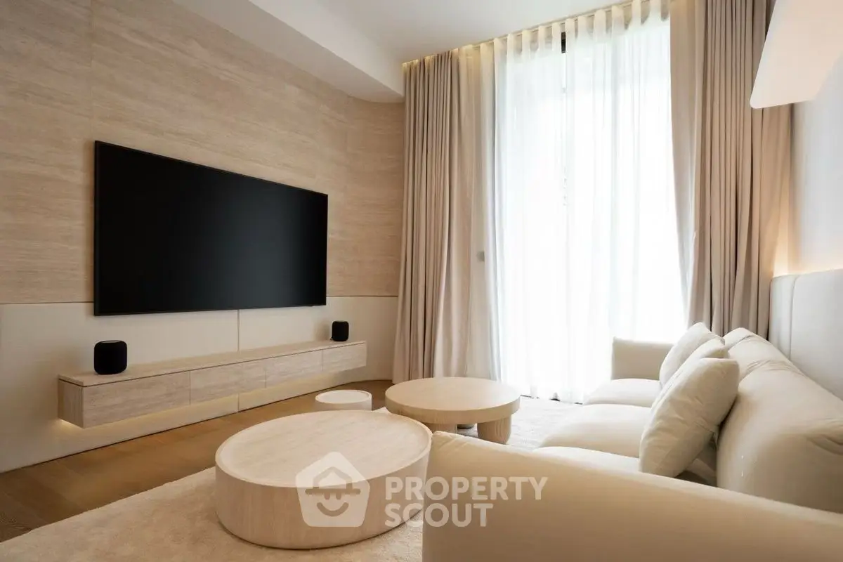 Luxurious modern living room with elegant decor and large flat-screen TV