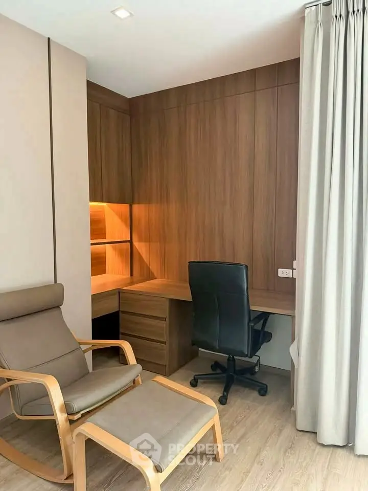 Modern study room with wooden desk and comfortable chair