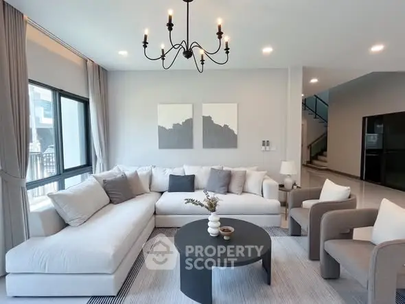 Spacious modern living room with elegant decor and large windows