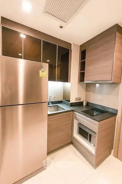 Modern kitchen with sleek cabinetry and stainless steel appliances in a compact layout.